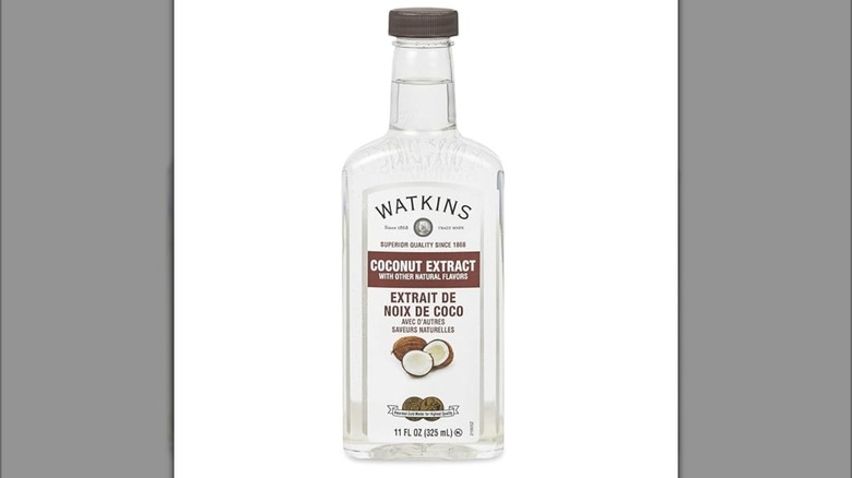 Bottle of coconut extract on white background