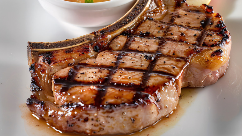 Close-up of a thick, grilled bone-in pork chop