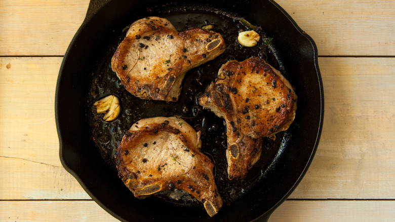 Pan-seared pork chops in a cast iron skillet