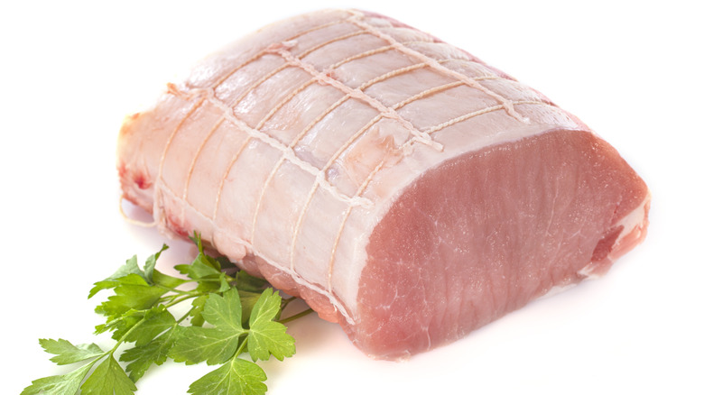 Raw pork loin against white background