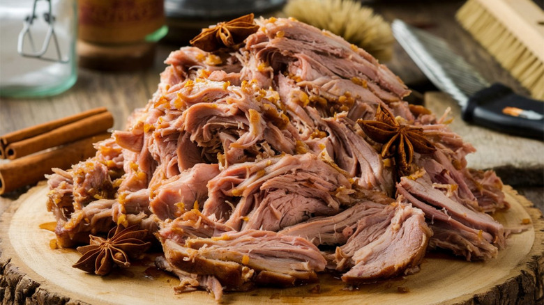 Large mound of pulled pork on a rustic serving platter