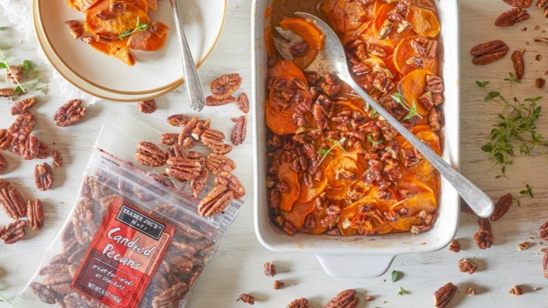 Candied pecans on table beside sweet potato casserole