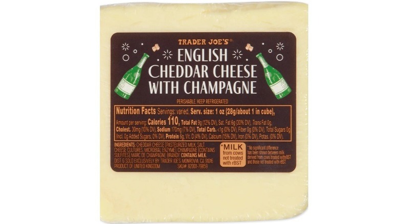 Block of English cheddar cheese with champagne