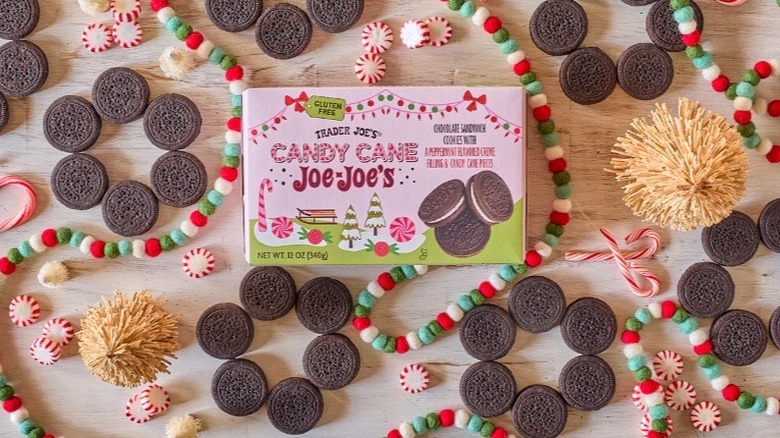 Box of candy cane Joe-Joe's surrounded by peppermints, cookies, and Christmas decorations