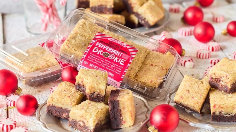 Squares of peppermint brookie on table with ornaments and peppermints