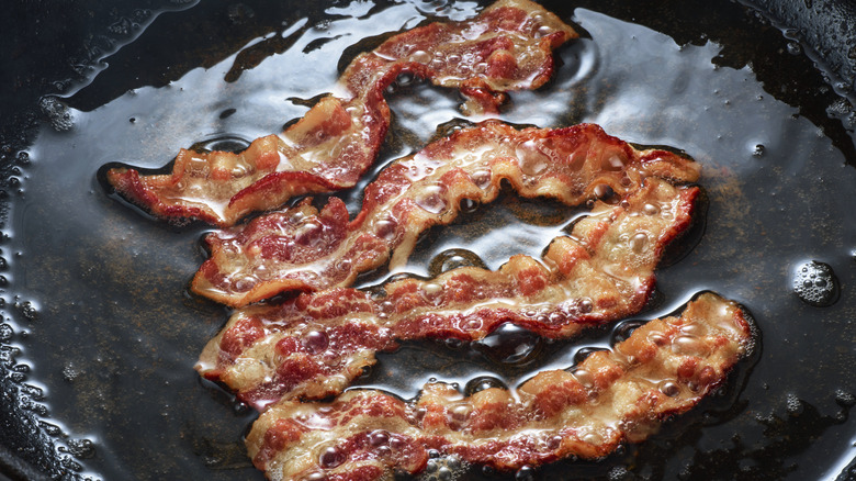 Bacon cooking in frying pan
