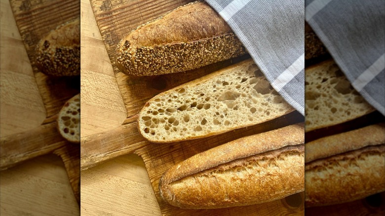 sliced and whole baguettes on cutting board from Seven Stars Bakery in Rhode Island