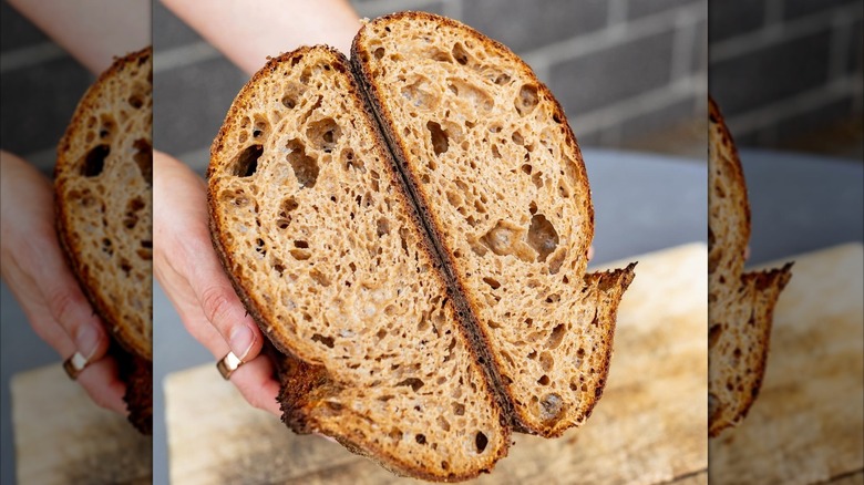 hands holding halved sourdough loaf from Seylou Bakery in Washington, DC