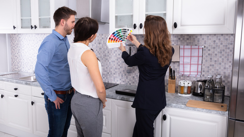 people looking at paint swatches in kitchen