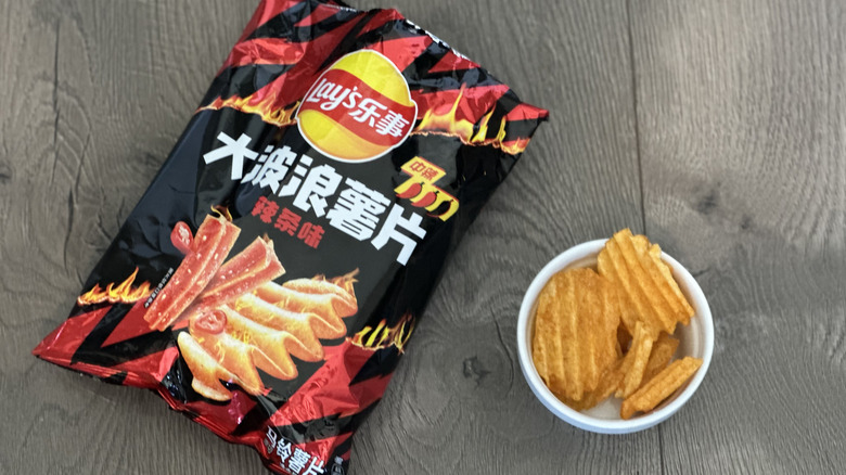 Overhead image of bag of Lay's Latiao flavored potato chips with small white ramekin filled with chips