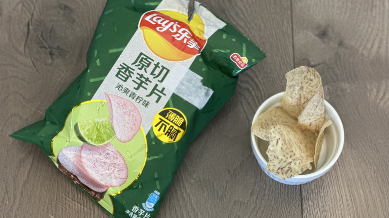 Overhead image of bag of Lay's Lemon flavored taro chips with small white ramekin filled with chips