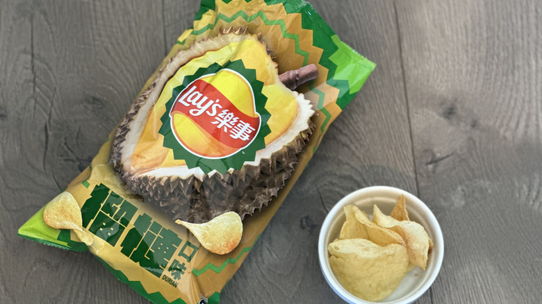 Overhead image of bag of Lay's Durian flavored potato chips with small white ramekin filled with chips