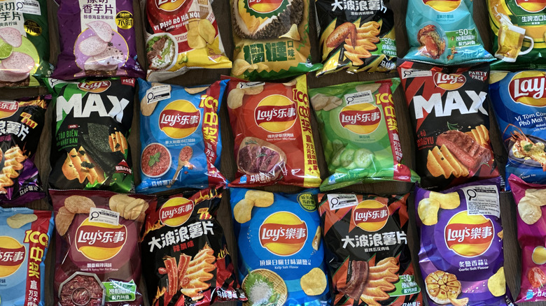 Overhead image of multiple bags of Lay's chips in international flavors