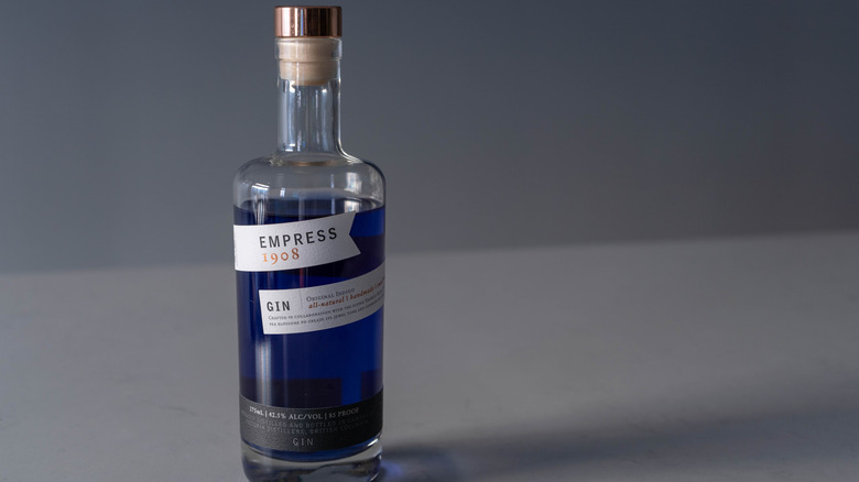 Bottle of Empress 1908 Gin on grey surface