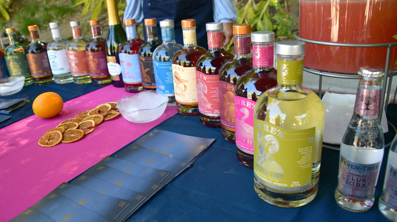 Bottles of Lyre's non-alcoholic spirits on blue and pink clothed table