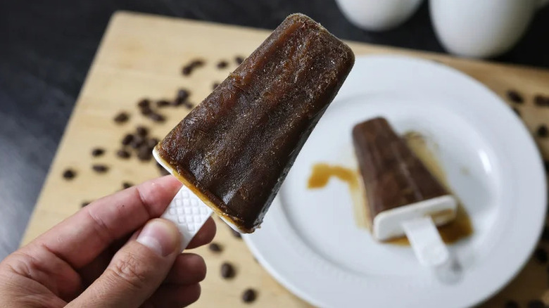 Hand holding a Boozy Espresso Martini Popsicle