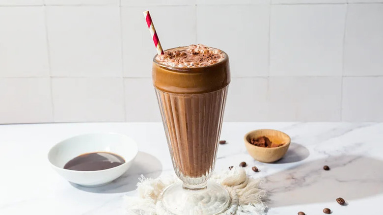 Coffee Lover's Egg Cream in glass on white countertop
