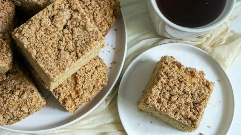 Espresso Crumb Coffee Cake on white plate with cup of coffee