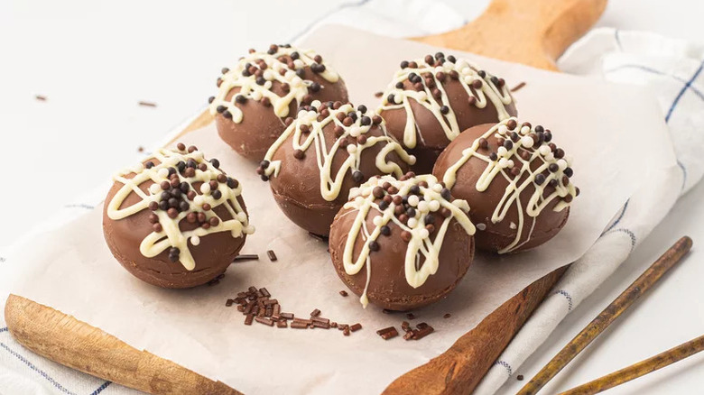 Mocha Bombs on parchment paper on wooden cutting board