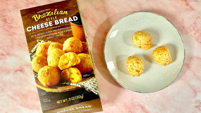 Trader Joe's Brazilian Cheese Balls on white plate next to box on pink table