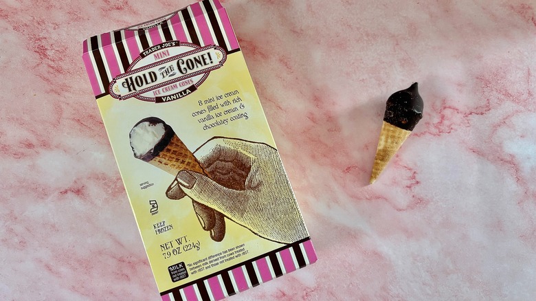Hold the Cone! box next to small ice cream cone on pink marble surface