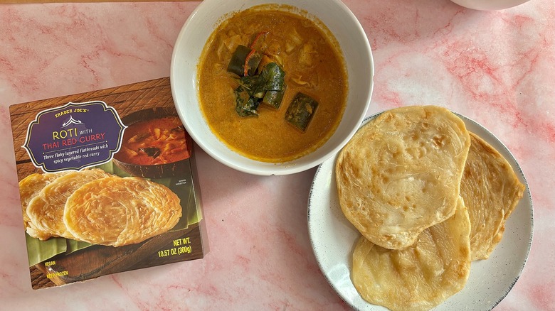 Trader Joe's roti with thai red curry next to box on pink marble surface