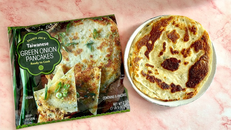 Taiwanese green onion pancake on plate next to package on pink marble surface