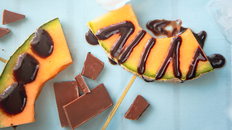 Slices of cantaloupe with dark chocolate drizzle