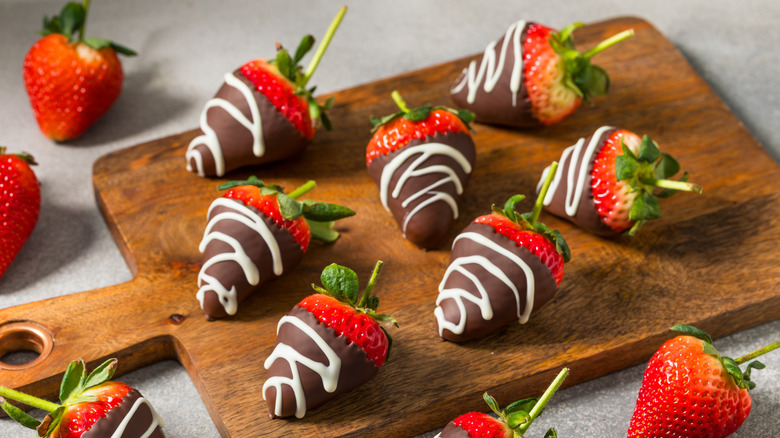 chocolate covered strawberries on wood board