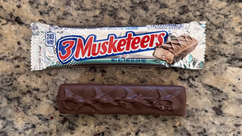 3 musketeers candy bar unwrapped on counter