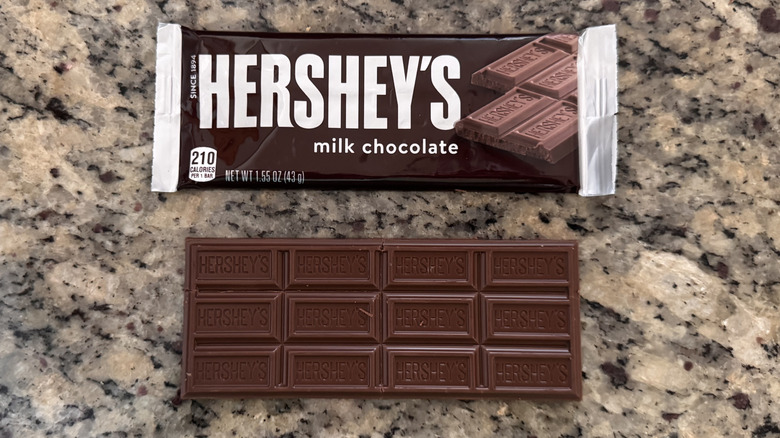 Hershey's bar on counter next to wrapper