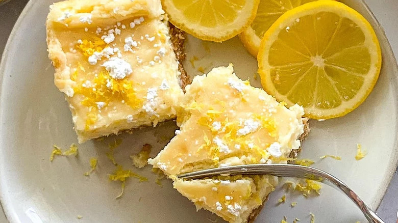Lemon cheesecake bar slices on a plate