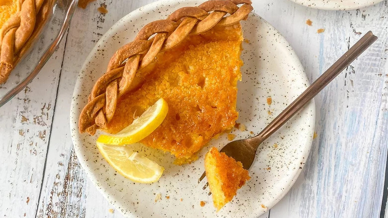 Slice of chess pie on a plate with a piece on a fork