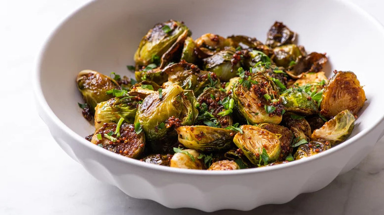 White bowl filled with crispy balsamic roasted Brussels sprouts