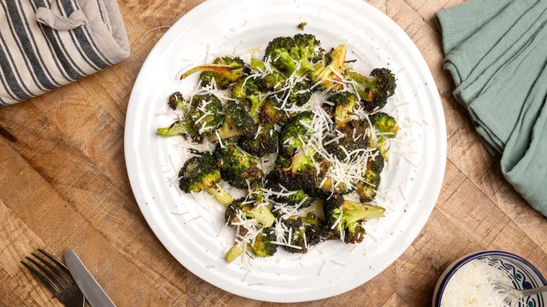 Plate of roasted garlic broccoli topped with Parmesan cheese