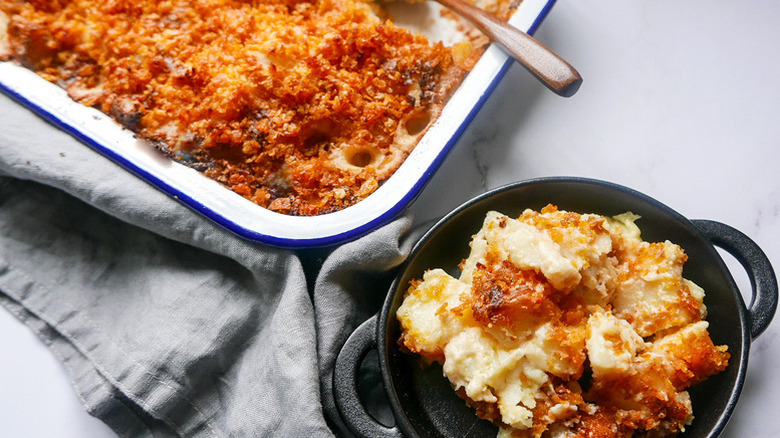 Crispy-topped cheesy funeral potatoes in baking dish and bowl
