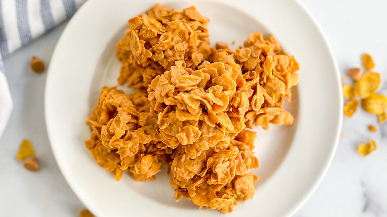 Pile of cornflake cookies on white plate