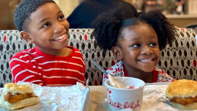 Two kids eating at Chick-fil-A