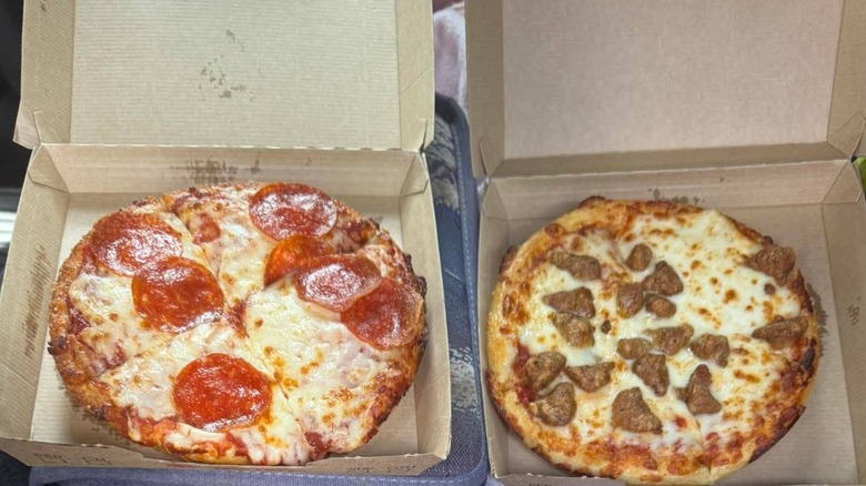 A pepperoni and a sausage Pizza Hut personal pan pizzas in their boxes