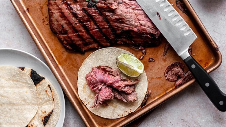carne asada on cutting board, taco