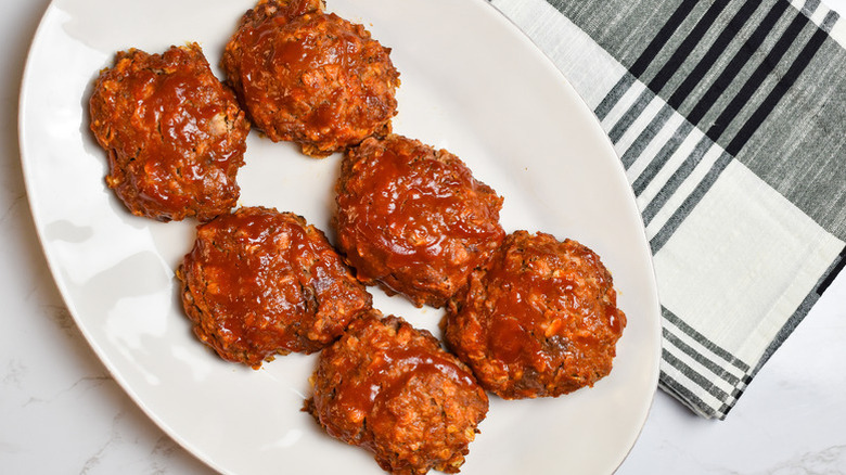 Glazed mini meatloaf patties on white plate