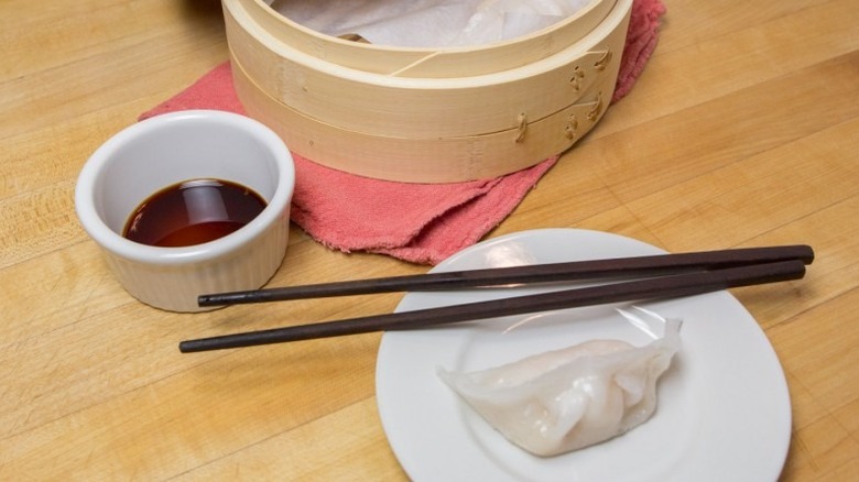 Cantonese-Style Shrimp Dumplings (Har Gow) on white plate with chopsticks