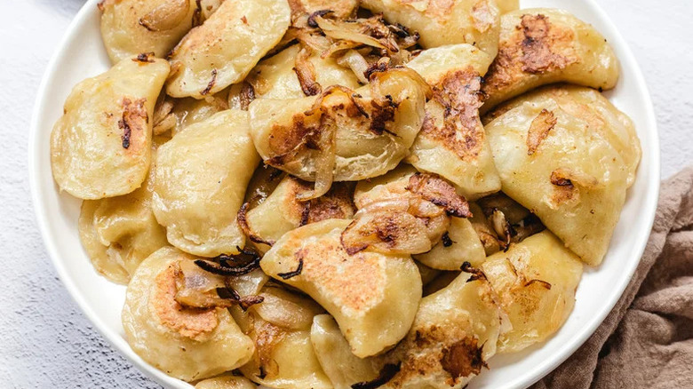 Pan-Fried Potato and Cheddar Pierogies on white plate