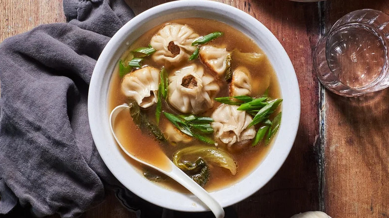 Pork and Chive Dumplings in Garlic-Miso Broth in white bowl