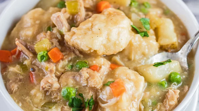 Quick Instant Pot Chicken and Dumplings in white bowl with spoon