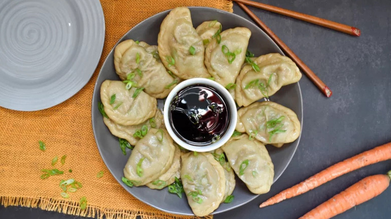 Steamed Beef Dumplings on grey plate with dipping sauce
