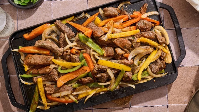 Colorful Ribeye Steak Fajitas on black griddle
