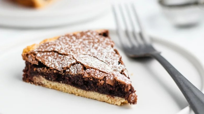 Slice of fudge pie on plate with fork