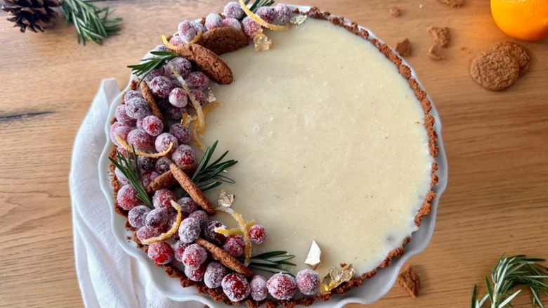 Winter white chocolate cranberry tart on wooden table