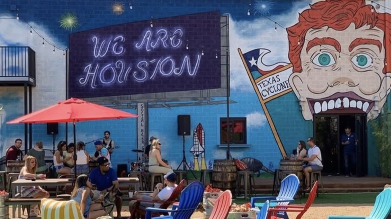 Outside murals and seating at Social Beer Garden Texas in Houston